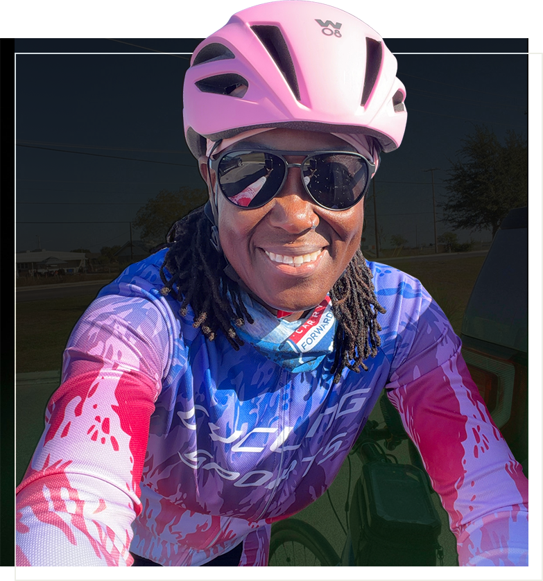 Emma Milne Woman wearing a pink bike helmet and smiling at the camera